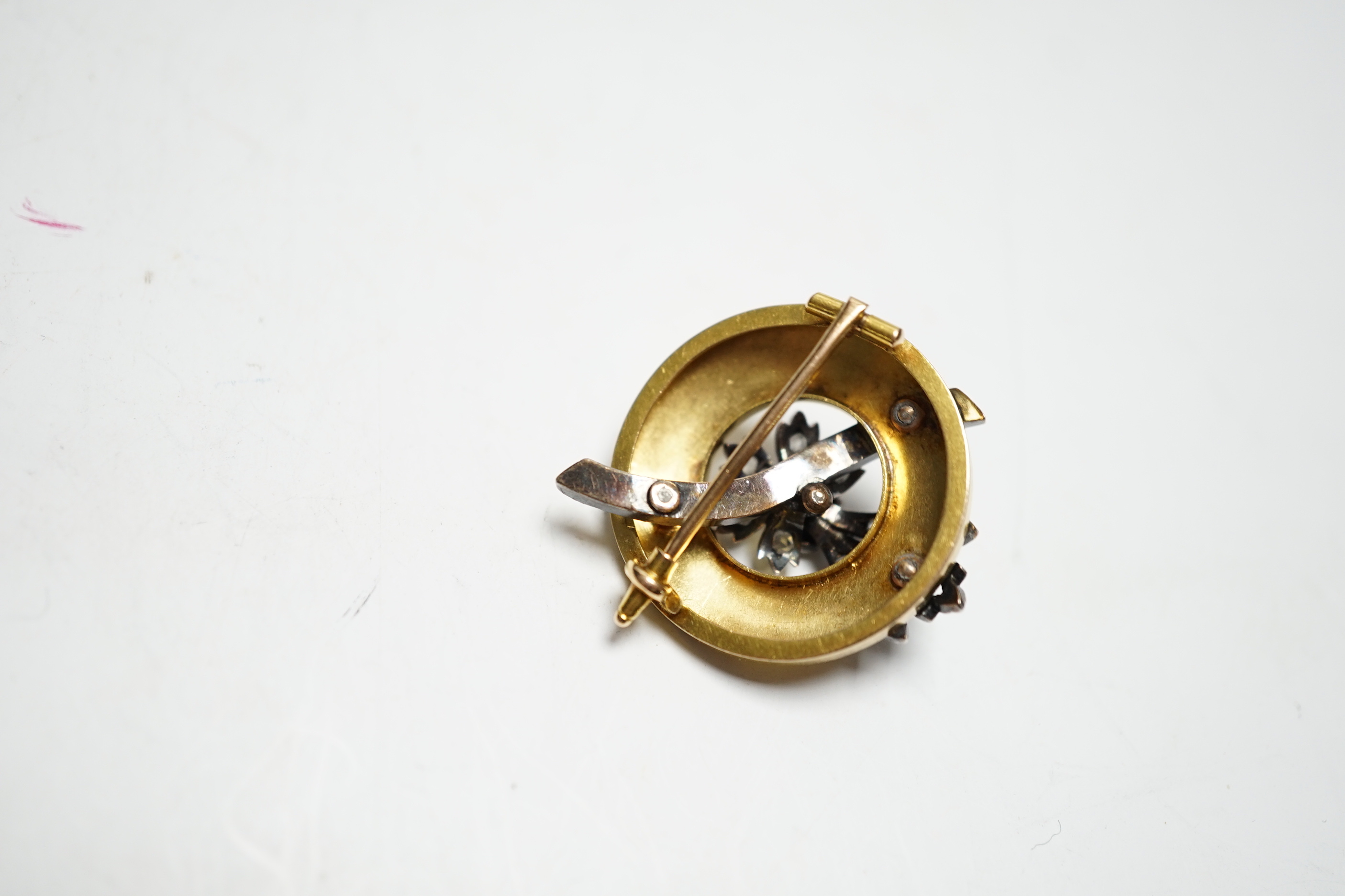 An early 20th century yellow metal and rose cut diamond cluster set circular brooch, 31mm, gross weight 10 grams.